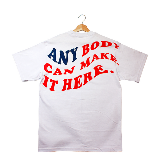 back of a t-shirt that says "anybody can make it here." in the silhouette of the American flag