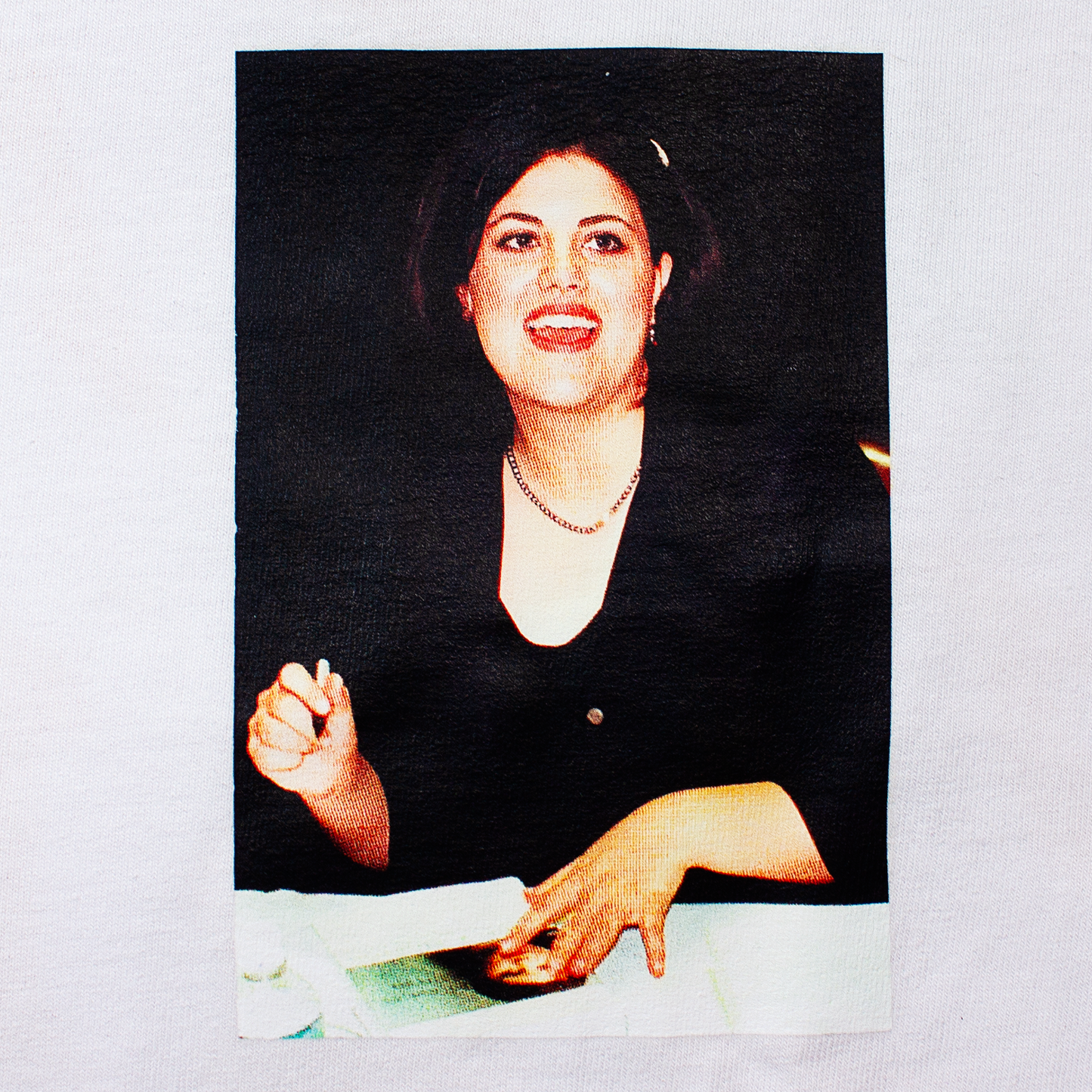 front of a white t-shirt with a photo a Monica Lewinsky signing her book about her affair with the president