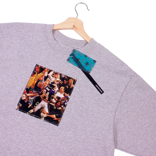 close up of grey t-shirt with a vintage cut out photo of Randy Moss celebrating scoring a touchdown