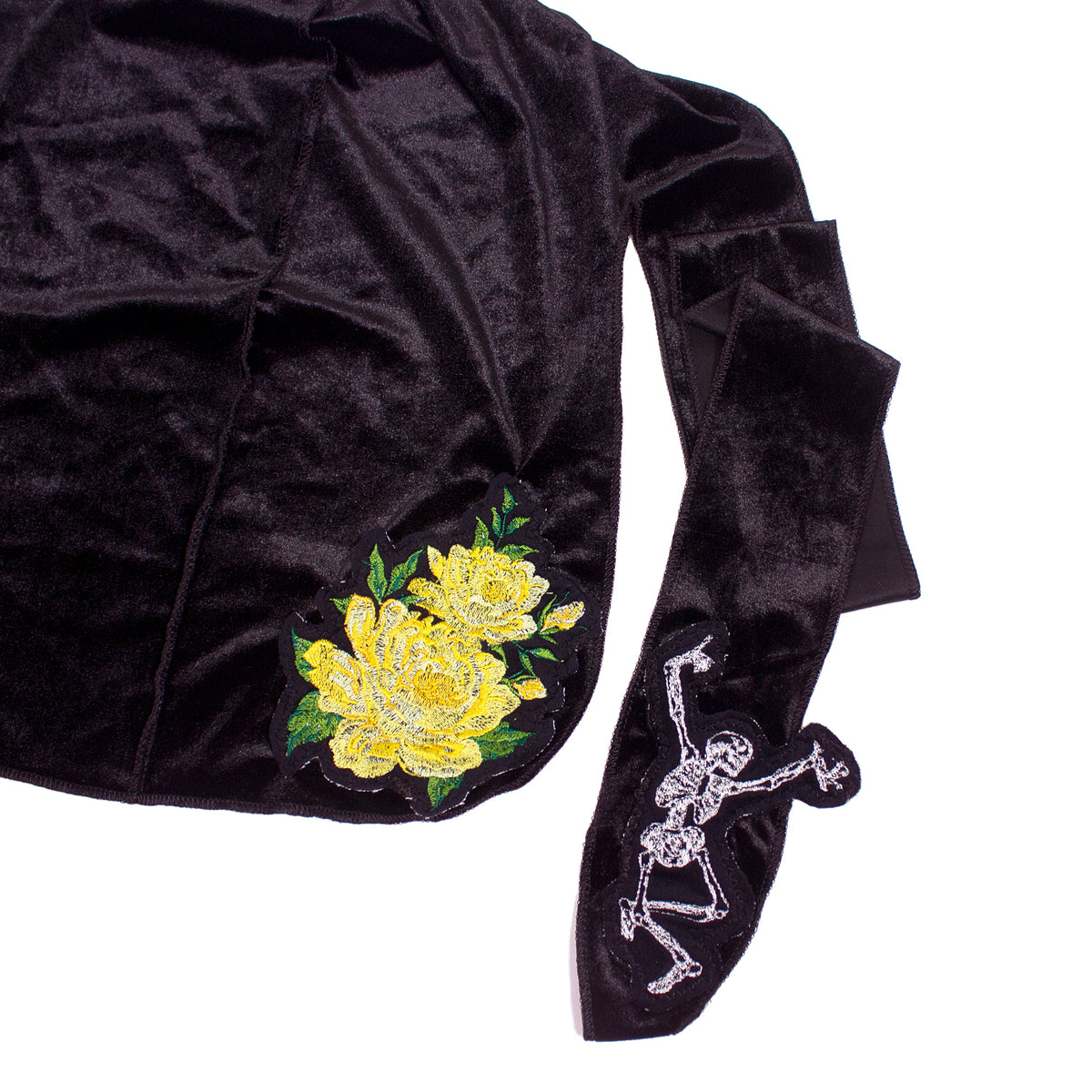 close up photo of a black du-rag with embroidered flower and skeleton