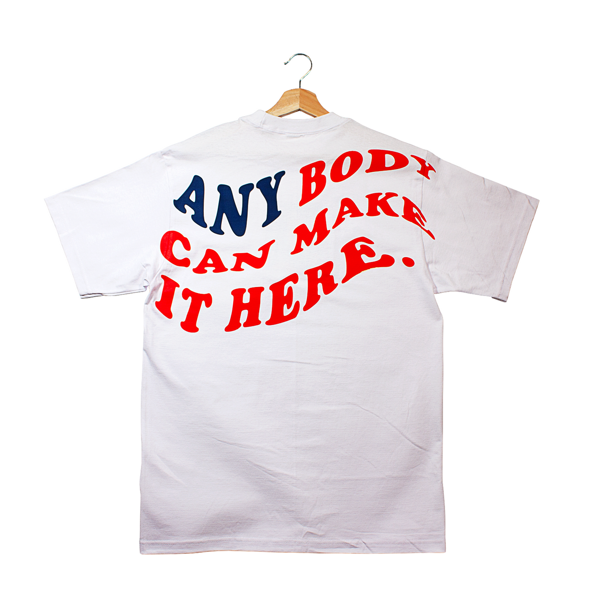 back of a t-shirt that says "anybody can make it here." in the silhouette of the American flag