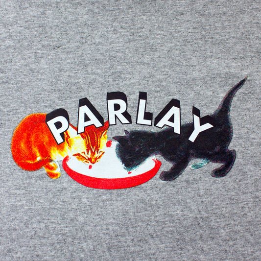 front of a t-shirt with PARLAY logo with an orange cat and black cat sharing the same bowl of milk. a love shared from a past life.