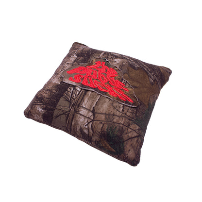 front of a pillow with real life camouflage pattern with "The Public Sucks" patch 