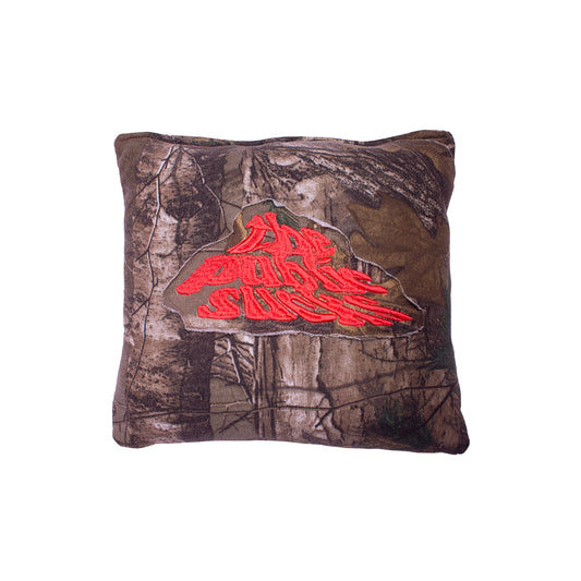 front of a pillow with real life camouflage pattern with "The Public Sucks" patch 