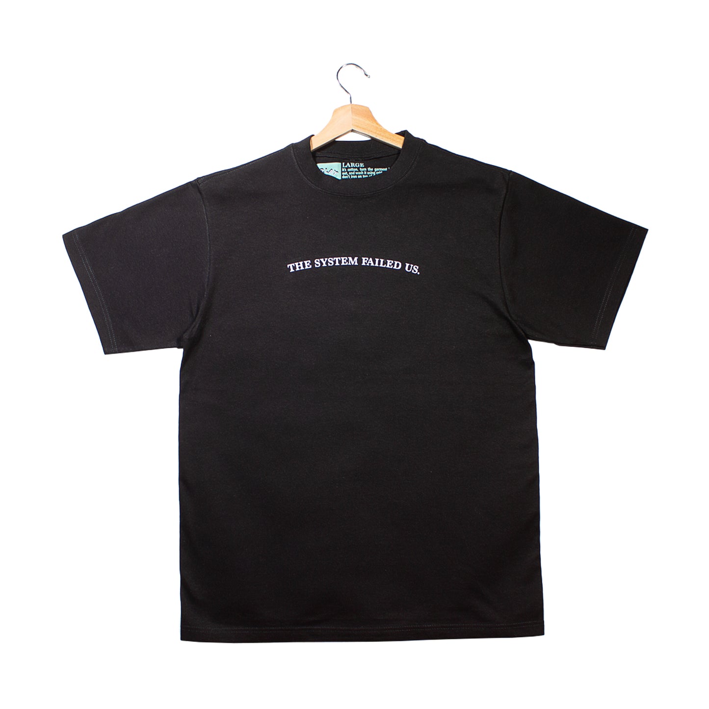 front of a black t-shirt with "the system failed us." graphic