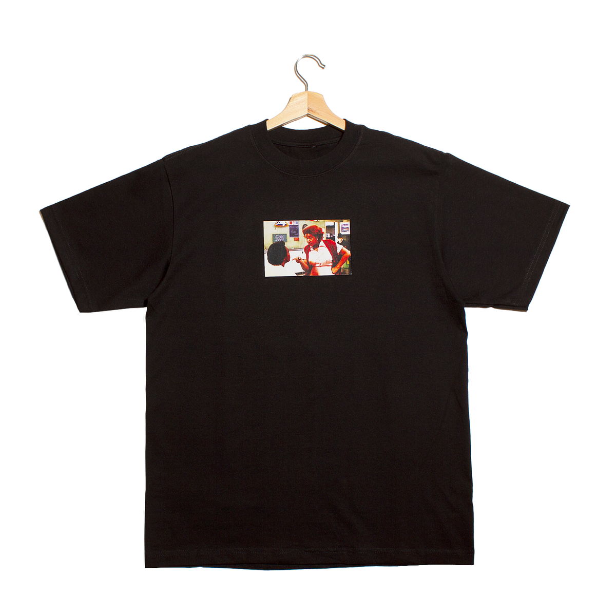 front a black t-shirt with a graphic of a photo from a scene of the movie Blue's Brothers showing Aretha Franklin telling her movie husband he better think about the consequences of his actions