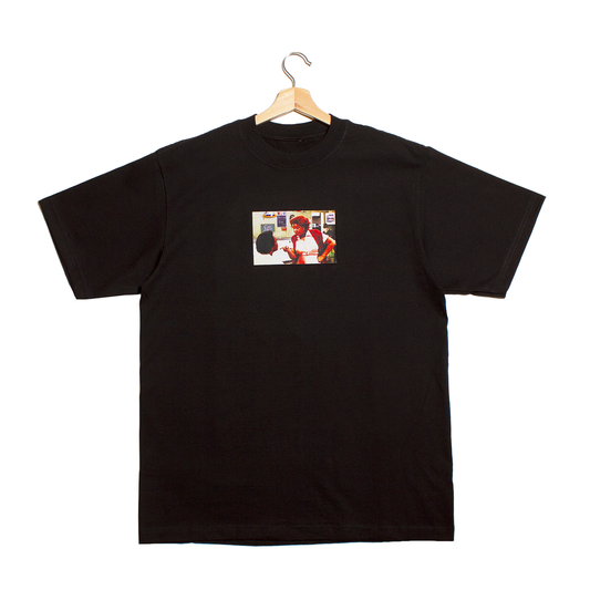 front a black t-shirt with a graphic of a photo from a scene of the movie Blue's Brothers showing Aretha Franklin telling her movie husband he better think about the consequences of his actions