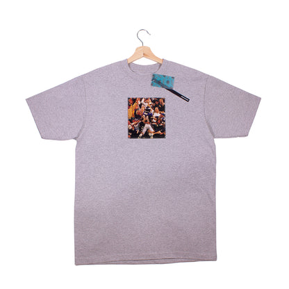 front of grey t-shirt with a vintage cut out photo of Randy Moss celebrating scoring a touchdown