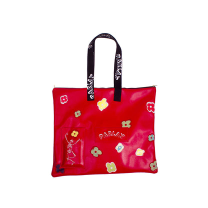 side of a over the shoulder bag with skeleton embroidered with screen printed flowers 