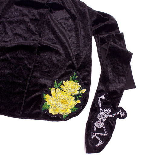 close up photo of a black du-rag with embroidered flower and skeleton